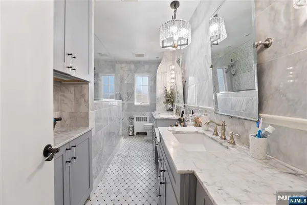 a spacious bathroom with double vanity and a mirror