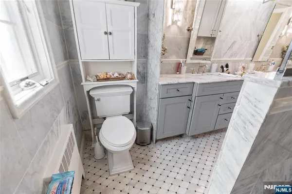 a bathroom with a sink toilet and window