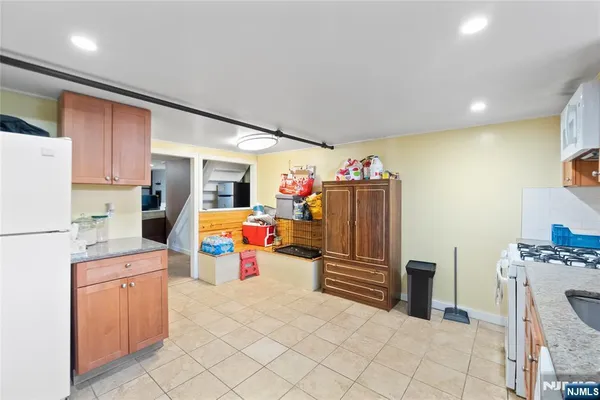 a view of kitchen with stainless steel appliances cabinets and refrigerator