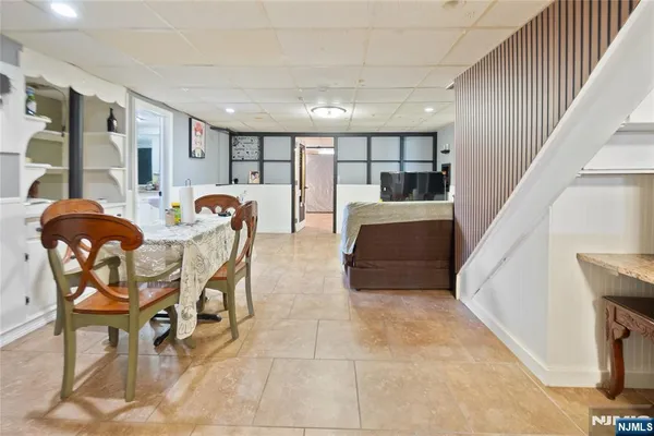 a dining room with furniture and wooden floor