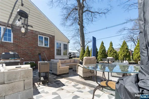 a view of a patio with couches table and chairs and potted plants