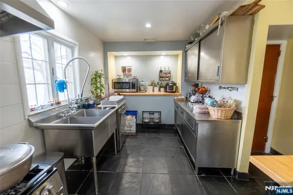 a kitchen with a sink appliances and cabinets