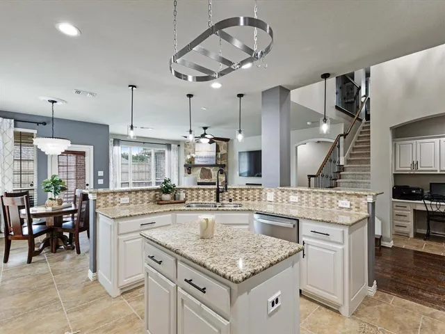 a kitchen with stainless steel appliances granite countertop a sink and stove