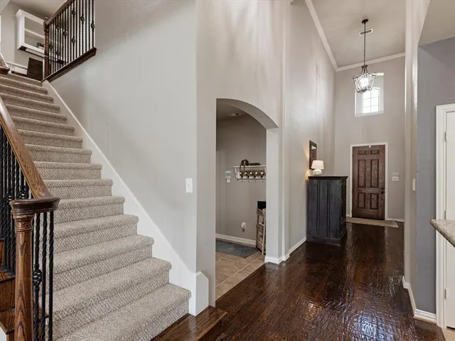a bedroom with a large bed and a chandelier