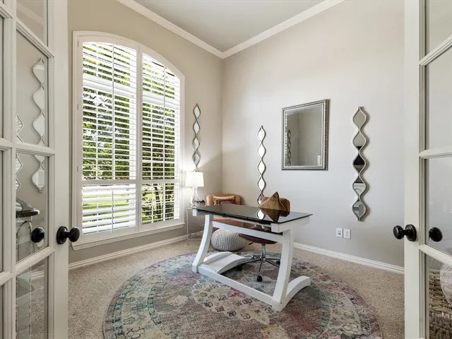 a living room with a window and a table