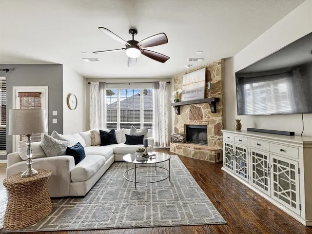 a living room with furniture fireplace and flat screen tv