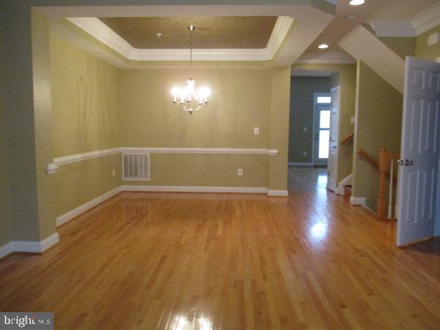 3547 Goddard Way Alexandria, VA 22304 - Photo 11 of 38 wooden floor in an empty room with a mirror
