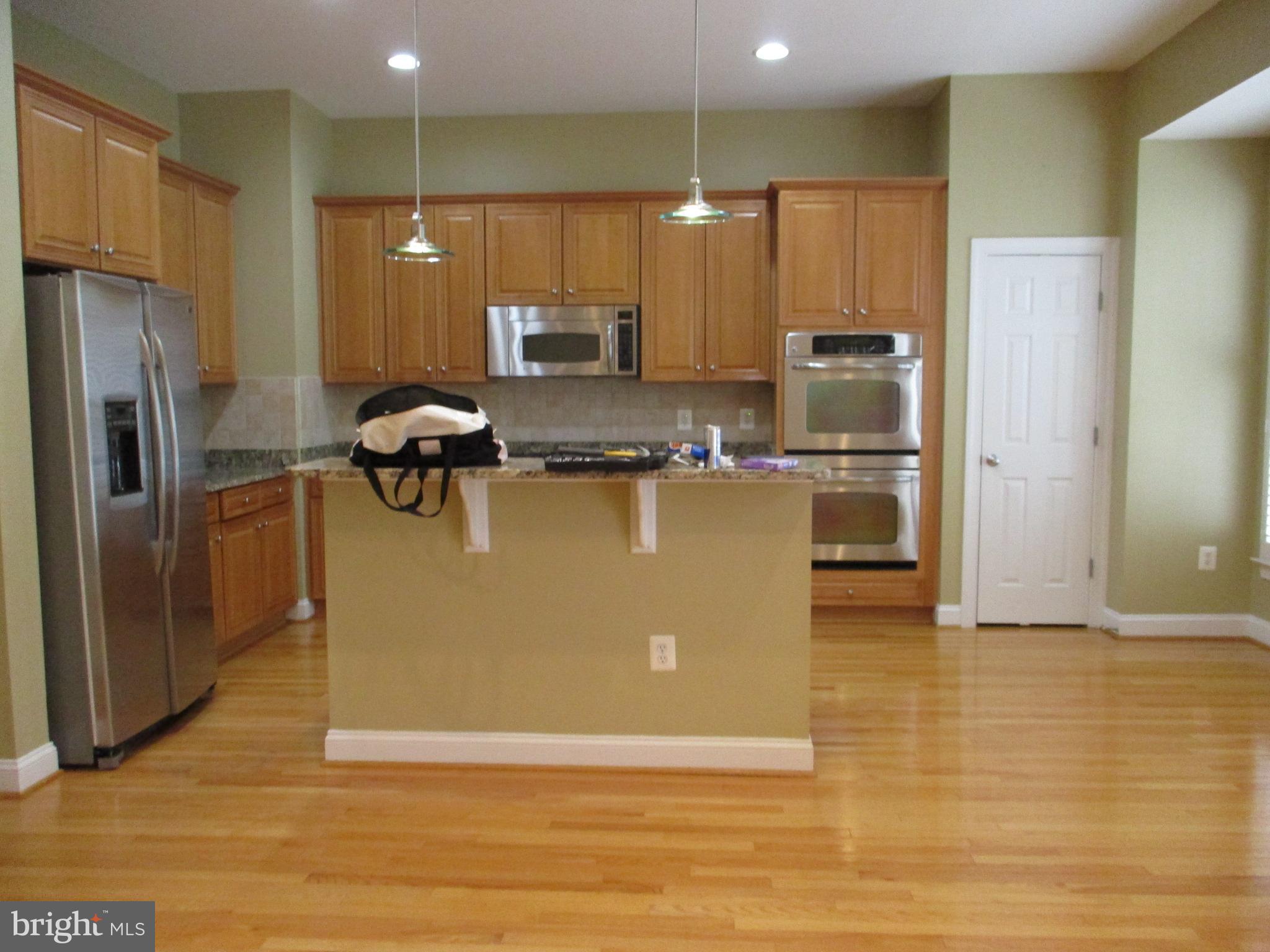 3547 Goddard Way Alexandria, VA 22304 - Photo 15 of 38 a view of a kitchen with kitchen island a sink wooden floor and stainless steel appliances