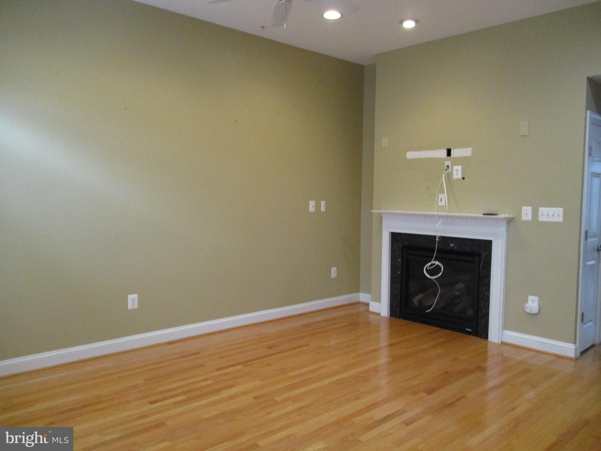 3547 Goddard Way Alexandria, VA 22304 - Photo 17 of 38 wooden floor in an empty room with a fireplace