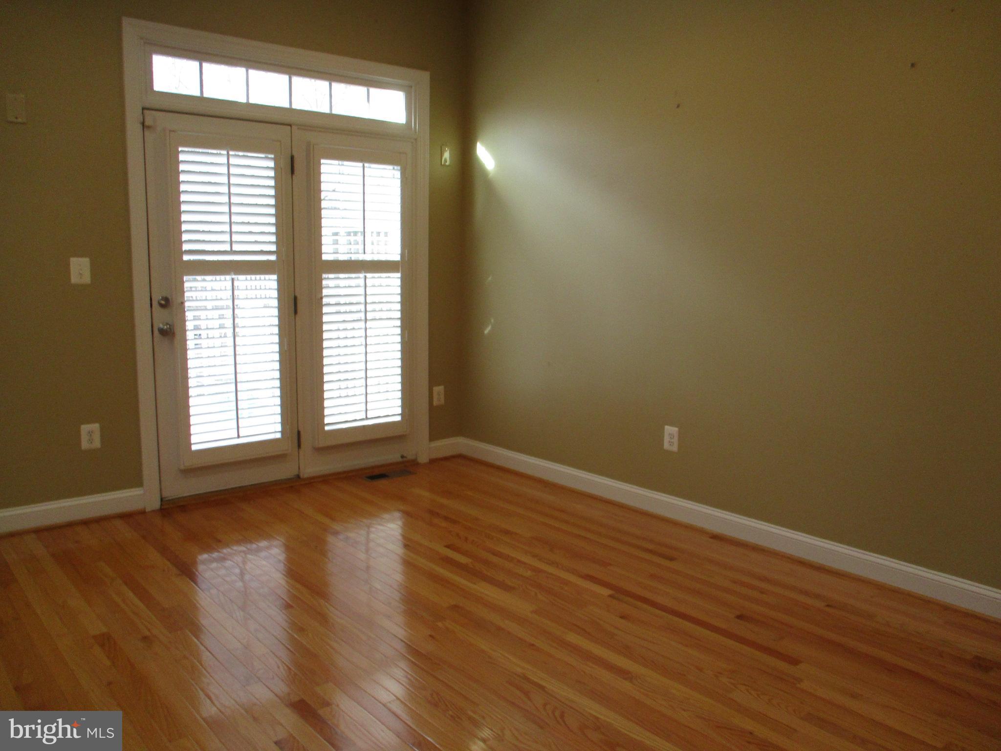 3547 Goddard Way Alexandria, VA 22304 - Photo 18 of 38 a view of an empty room with wooden floor and a window