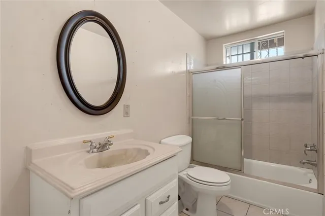 a bathroom with a shower a toilet and a window