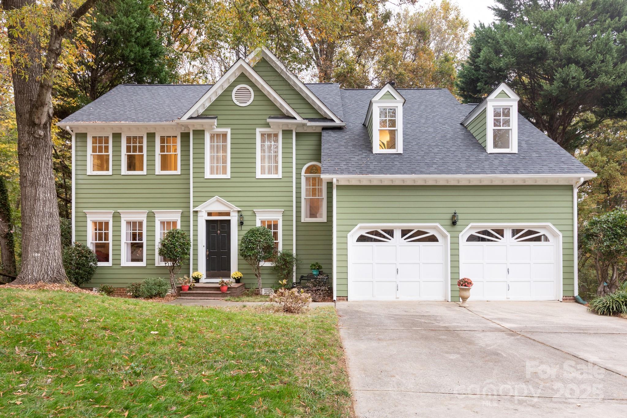 a front view of a house with a yard and garage