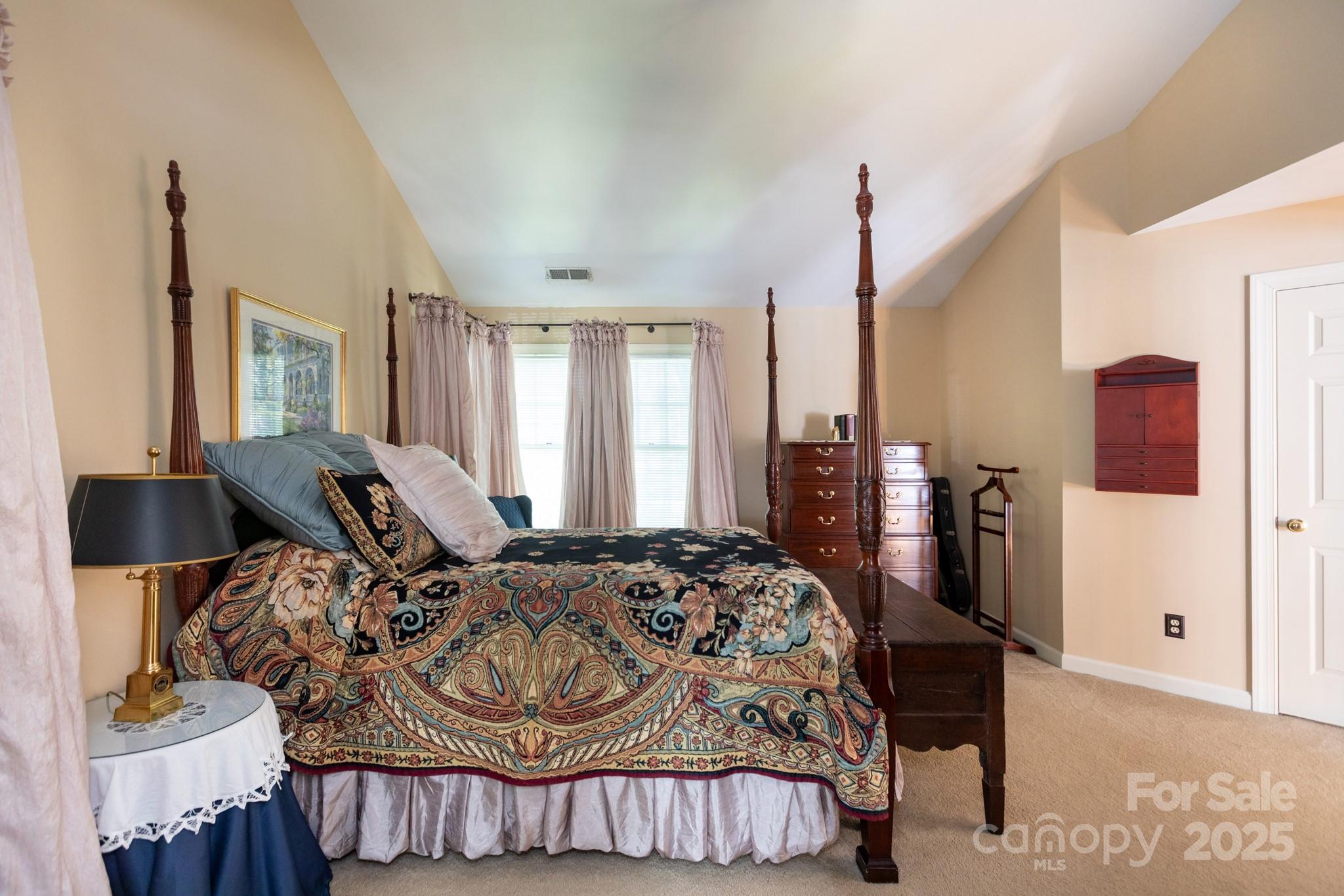 9112 Laurel Ridge Trail Charlotte, NC 28269 - Photo 14 of 38 a bedroom with a bed large window and wall painting