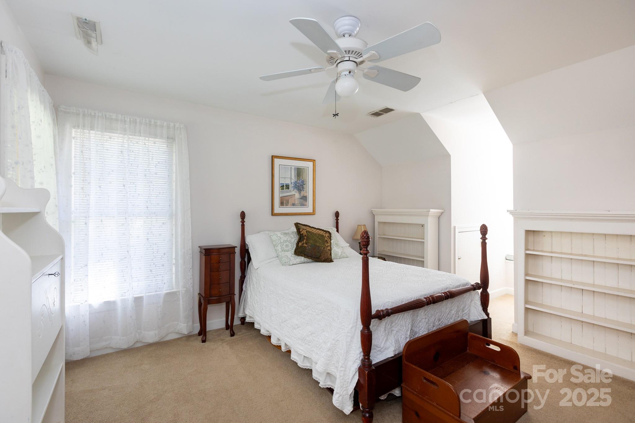 9112 Laurel Ridge Trail Charlotte, NC 28269 - Photo 18 of 38 a bedroom with a bed a window and ceiling fan
