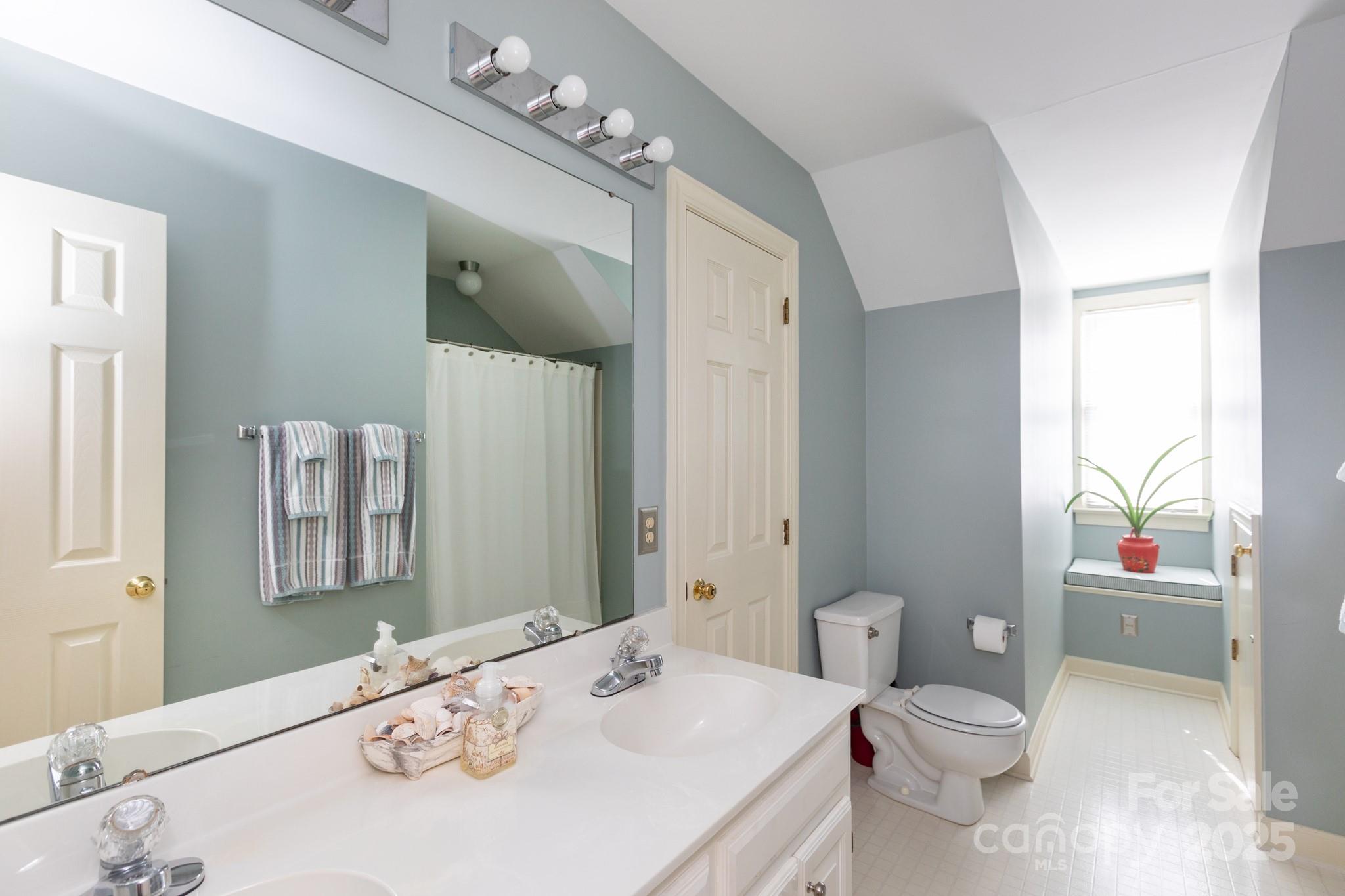 9112 Laurel Ridge Trail Charlotte, NC 28269 - Photo 21 of 38 a bathroom with a sink a toilet and shower curtain