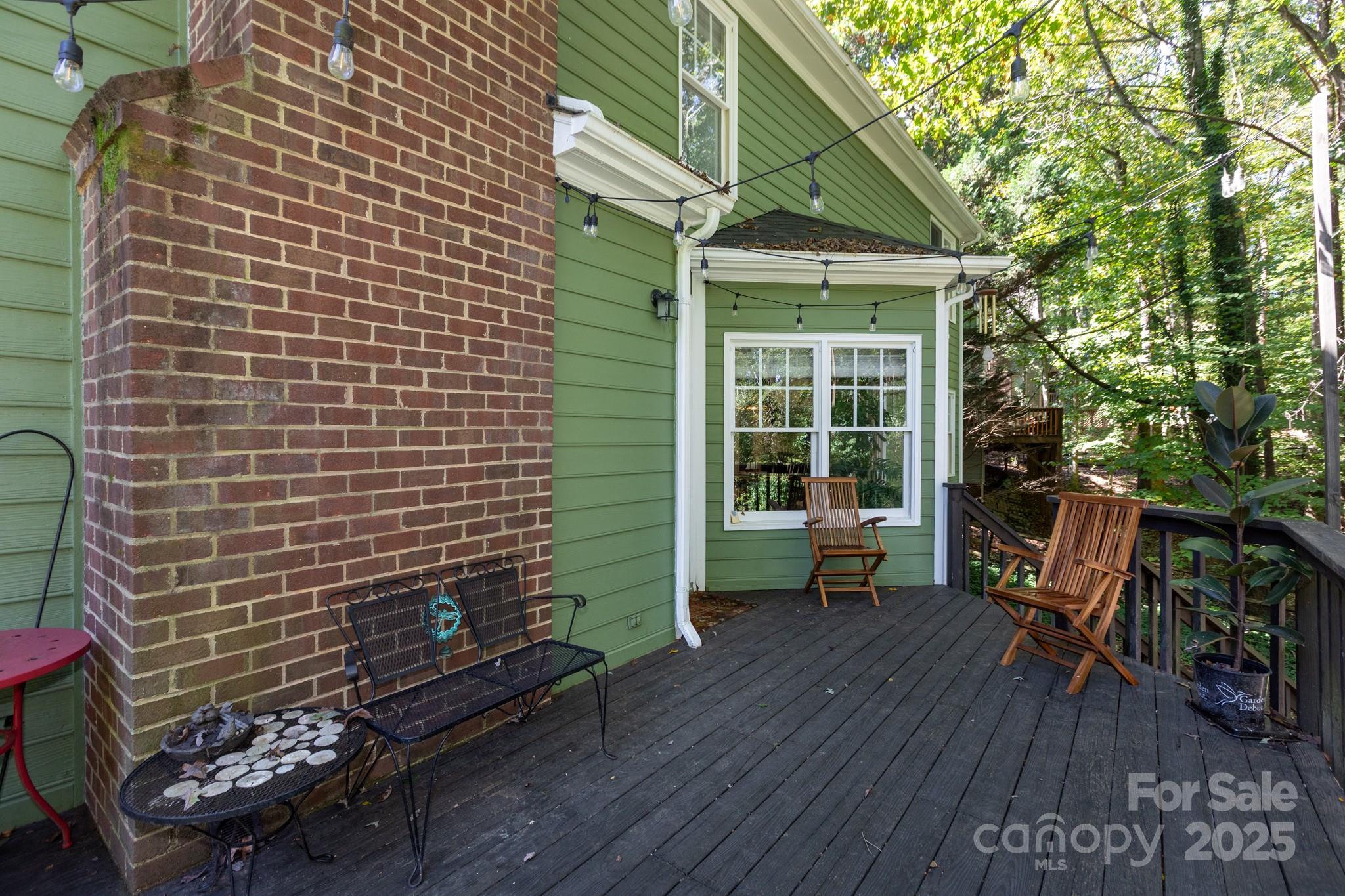 9112 Laurel Ridge Trail Charlotte, NC 28269 - Photo 22 of 38 a porch with seating space and a forest view