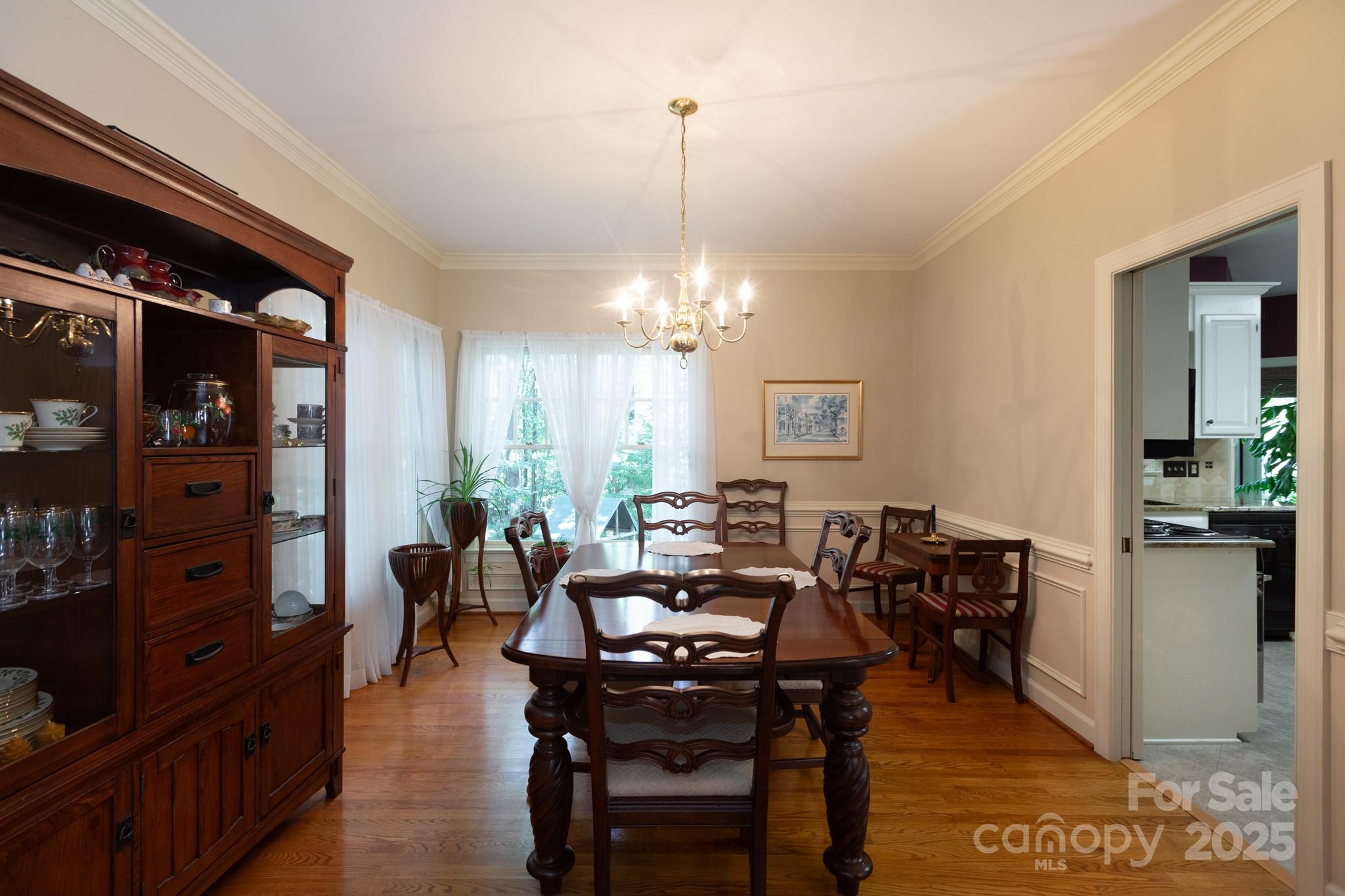 9112 Laurel Ridge Trail Charlotte, NC 28269 - Photo 6 of 38 a living room with furniture a chandelier and a dining table