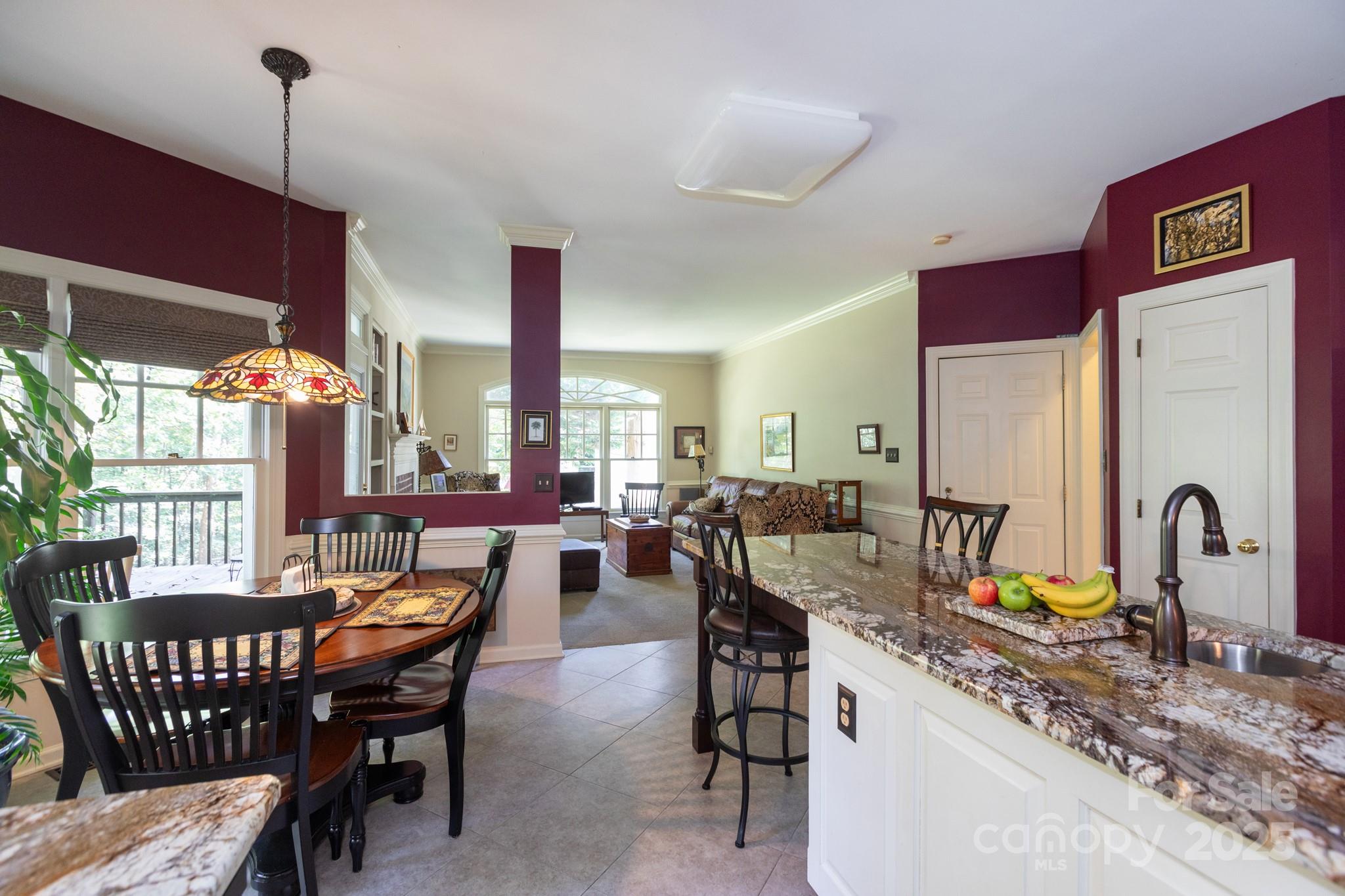 9112 Laurel Ridge Trail Charlotte, NC 28269 - Photo 10 of 38 a view of a dining room and livingroom with furniture wooden floor a rug a painting and a chandelier
