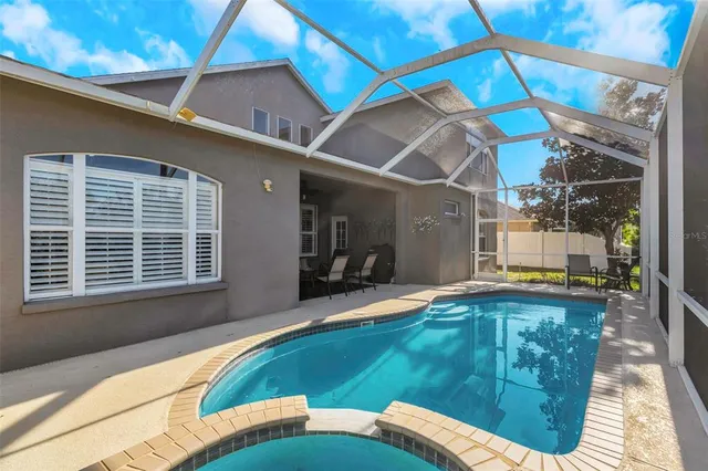 a view of a house with backyard and porch
