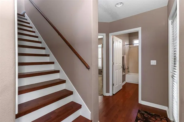 a view of entryway with wooden floor and stairs