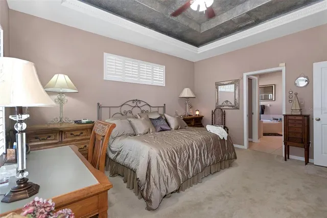 a bedroom with a bed and a lamp on dresser