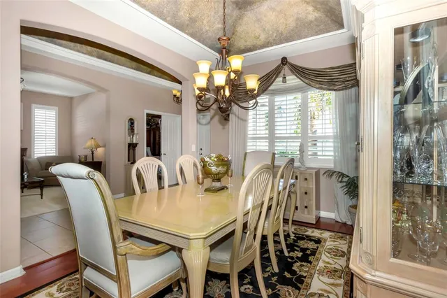 a view of a dining room with furniture and a chandelier