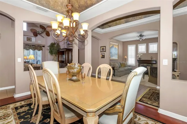 a view of a dining room with furniture and chandelier