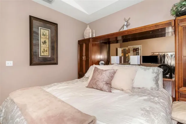 a bedroom with a large bed and a walk in closet