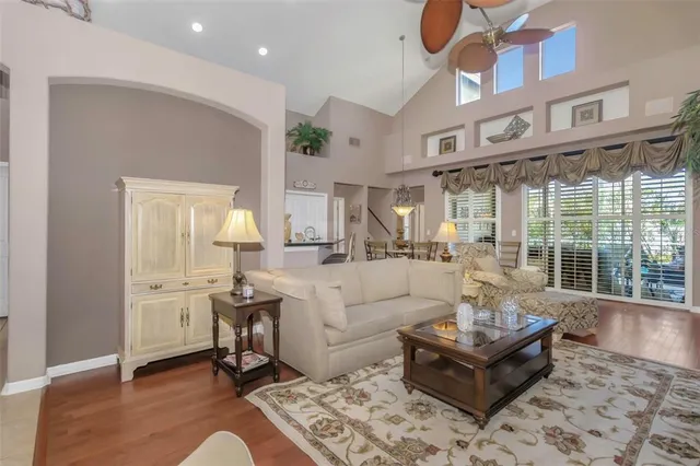a living room with fireplace furniture and a large window
