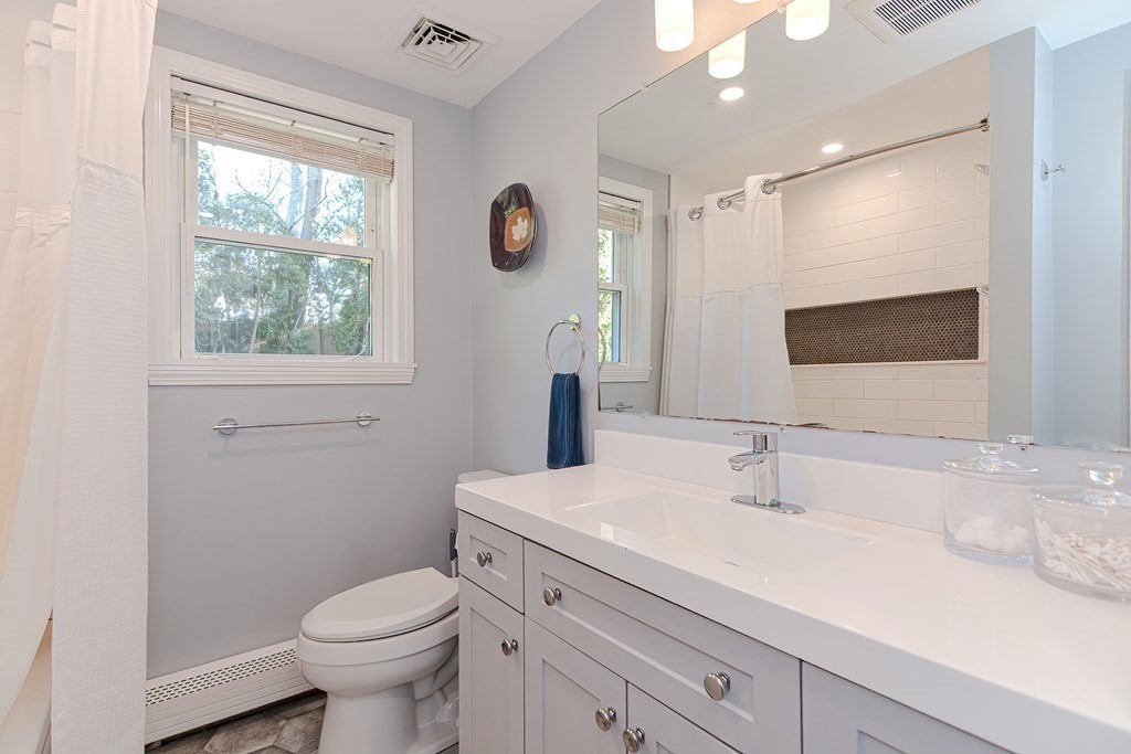 14 Oakcrest Drive Framingham, MA 01701 - Photo 17 of 42 a bathroom with a sink toilet and large mirror