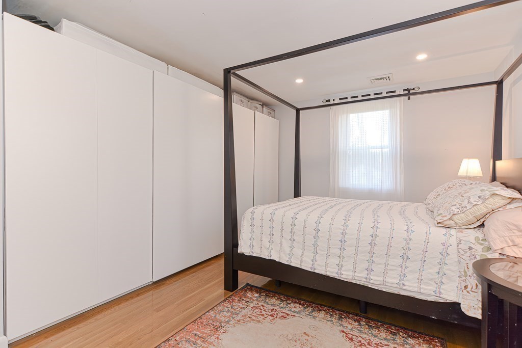 14 Oakcrest Drive Framingham, MA 01701 - Photo 19 of 42 a bedroom with a bed and wooden floor