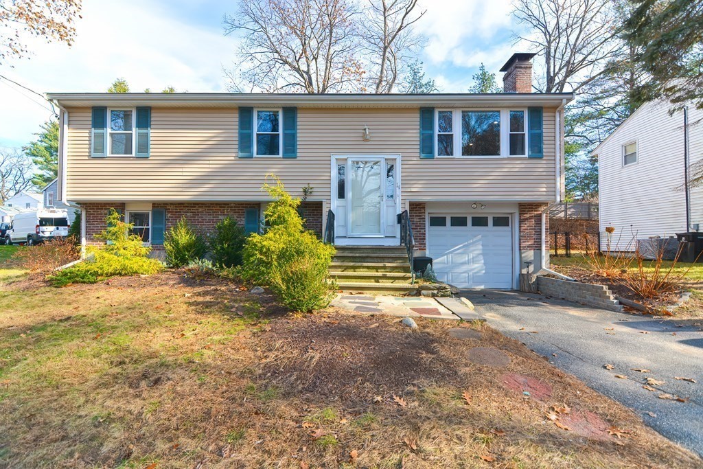 14 Oakcrest Drive Framingham, MA 01701 - Photo 39 of 42 a front view of a house with a yard and garage