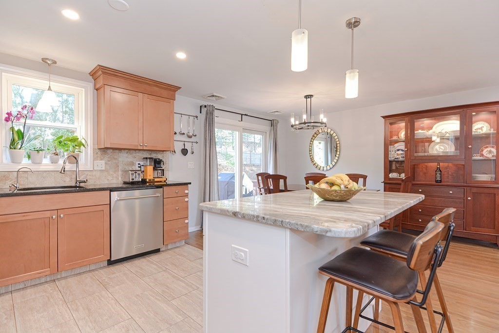 14 Oakcrest Drive Framingham, MA 01701 - Photo 6 of 42 a kitchen with a table chairs stove and refrigerator