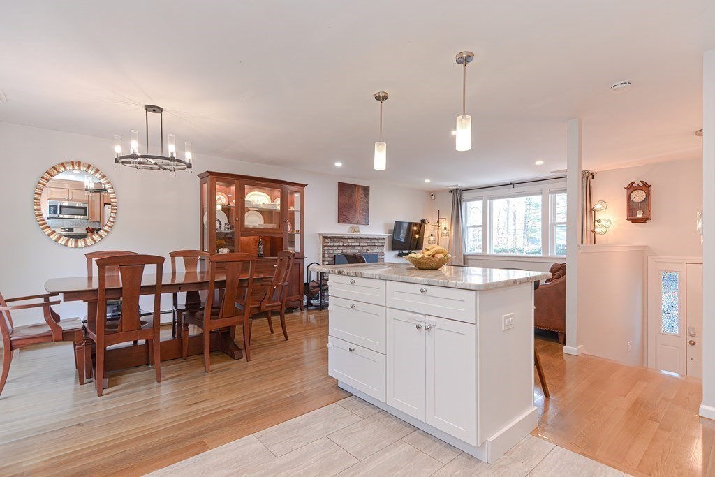 14 Oakcrest Drive Framingham, MA 01701 - Photo 9 of 42 a kitchen with stainless steel appliances kitchen island granite countertop a table chairs and a chandelier