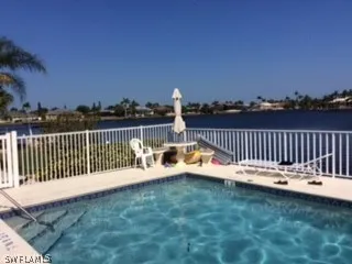 a view of roof deck with two chairs and a table
