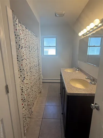 a bathroom with a sink and shower