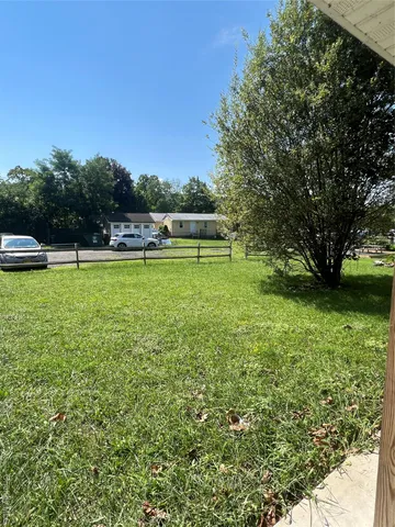 a view of a swimming pool and a yard