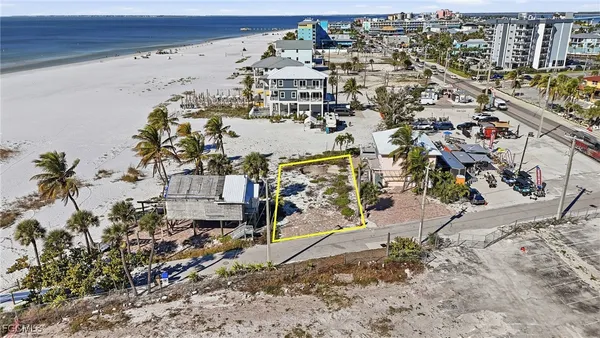 an aerial view of a house with a yard and lake view