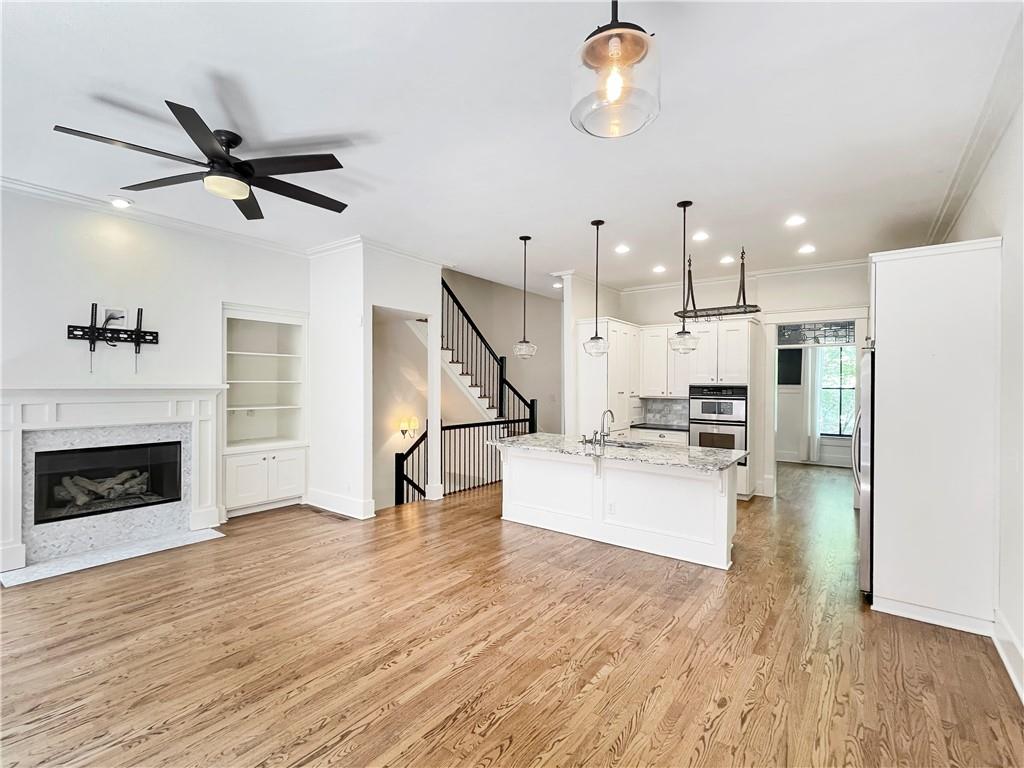 1867 Gordon Manor Northeast Atlanta, GA 30307 - Photo 11 of 34 a living room with stainless steel appliances kitchen island fireplace and wooden floor
