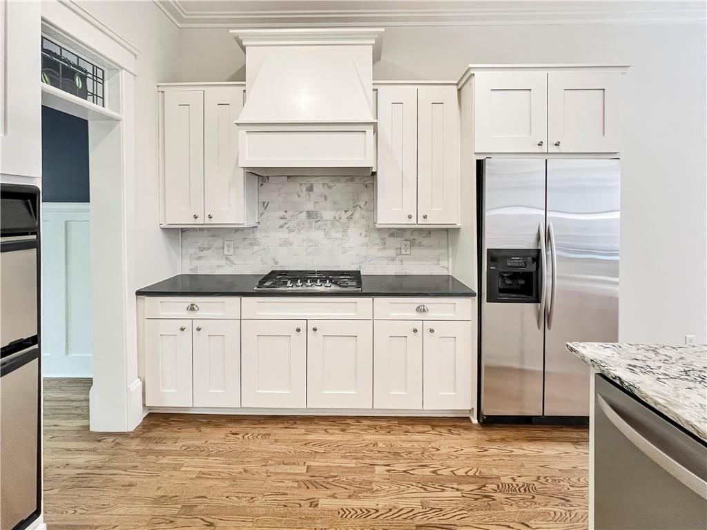 1867 Gordon Manor Northeast Atlanta, GA 30307 - Photo 15 of 34 a kitchen with stainless steel appliances granite countertop a refrigerator a stove and white cabinets