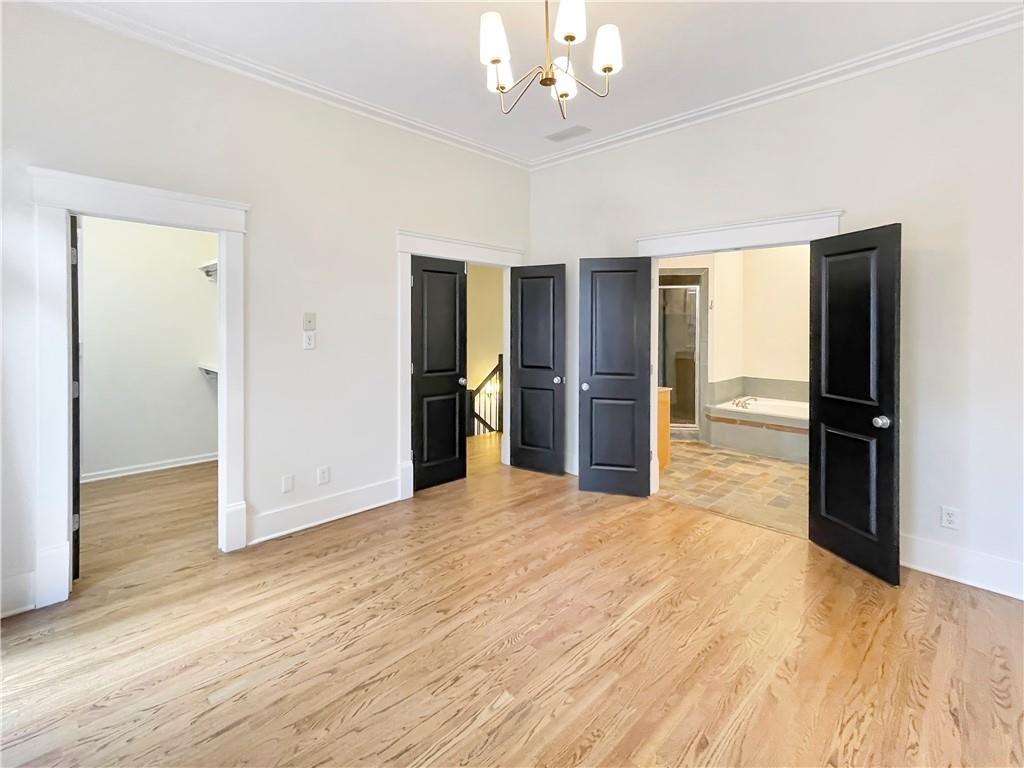 1867 Gordon Manor Northeast Atlanta, GA 30307 - Photo 23 of 34 a view of an empty room with wooden floor and a kitchen