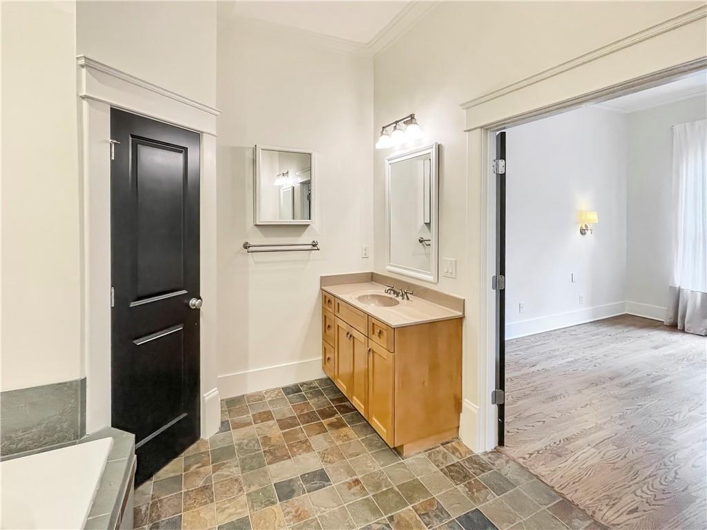 1867 Gordon Manor Northeast Atlanta, GA 30307 - Photo 26 of 34 a bathroom with a granite countertop sink and a refrigerator