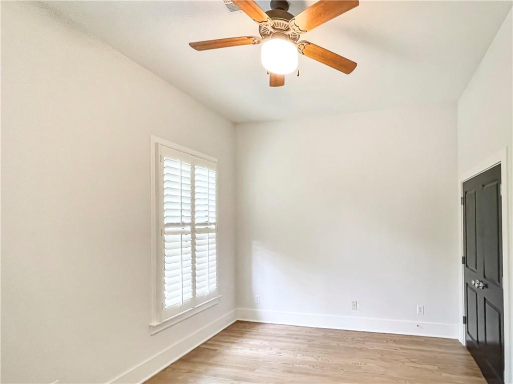 1867 Gordon Manor Northeast Atlanta, GA 30307 - Photo 27 of 34 an empty room with wooden floor fan and windows