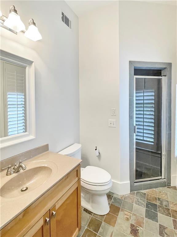 1867 Gordon Manor Northeast Atlanta, GA 30307 - Photo 28 of 34 a bathroom with a sink toilet and shower