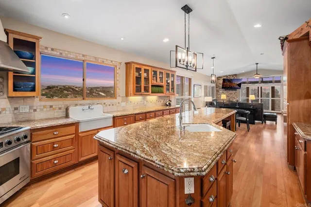 a bedroom with a bed a dresser and painting on the wall
