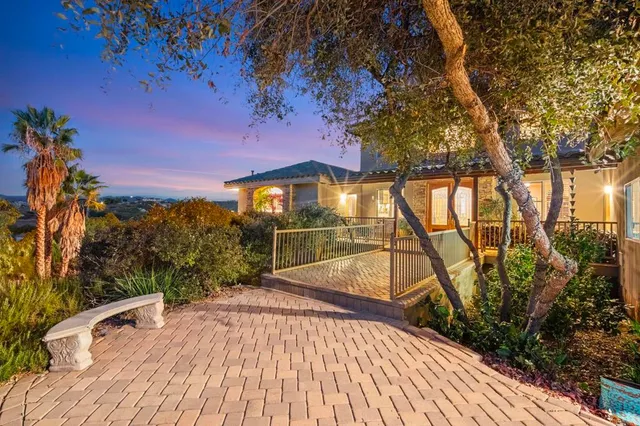 a view of a patio with a table and chairs under an umbrella