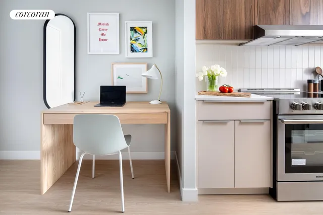 a bedroom with a bed a mirror and windows