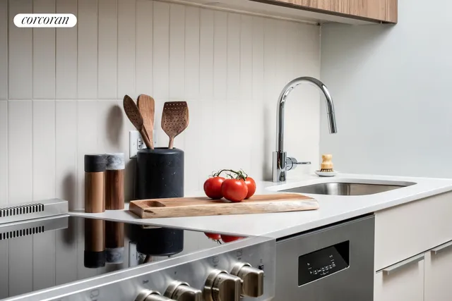 a kitchen with stainless steel appliances kitchen island granite countertop a table chairs and a refrigerator