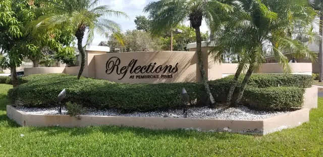 a sign that is sitting on a brick wall