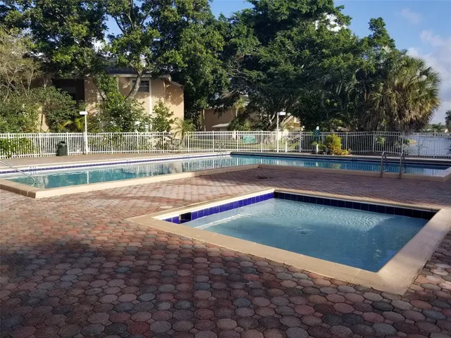 a view of a swimming pool with a yard